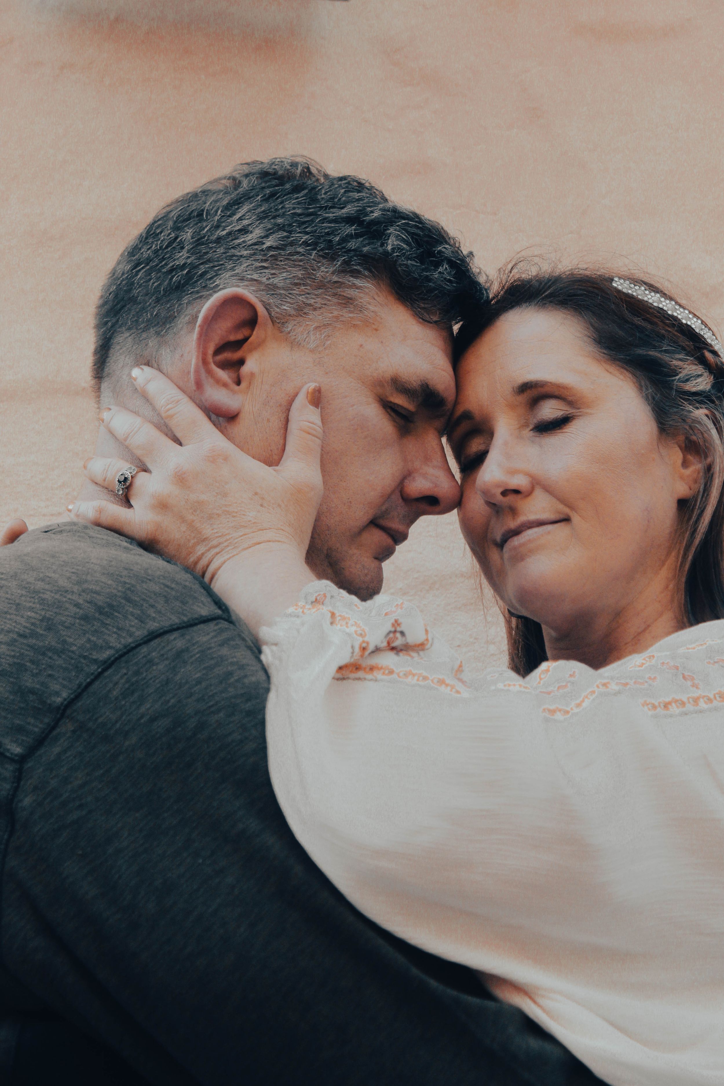 Romantic sepia-toned portrait of couple in intimate pose.