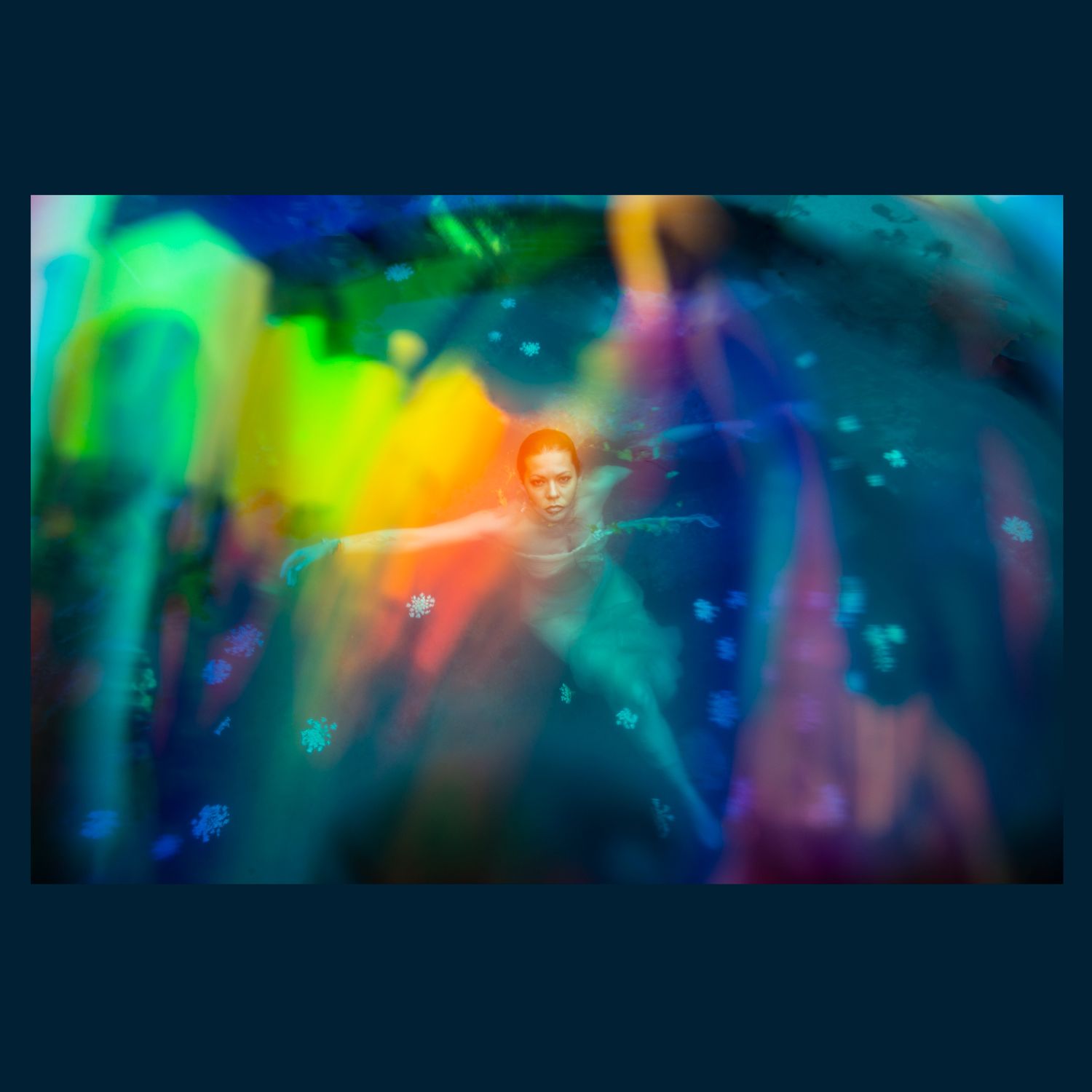 Abstract colorful light painting with flowing rainbow colors in dark background.