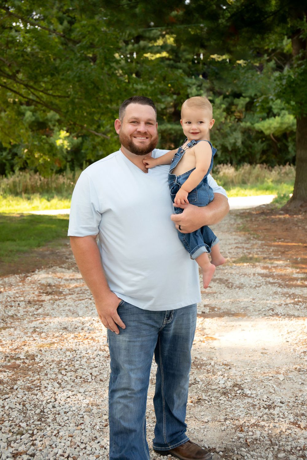 A tender moment between parent and child on a gravel path.