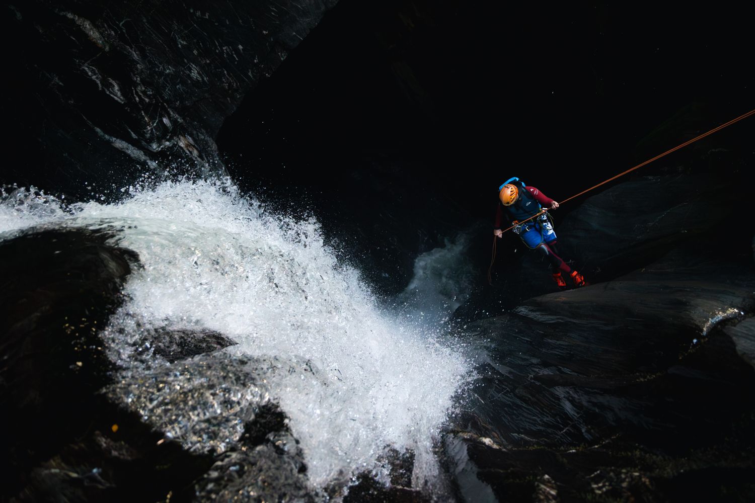 Dynamic waterfall shots showing powerful water flow against dark rocky backdrop.
