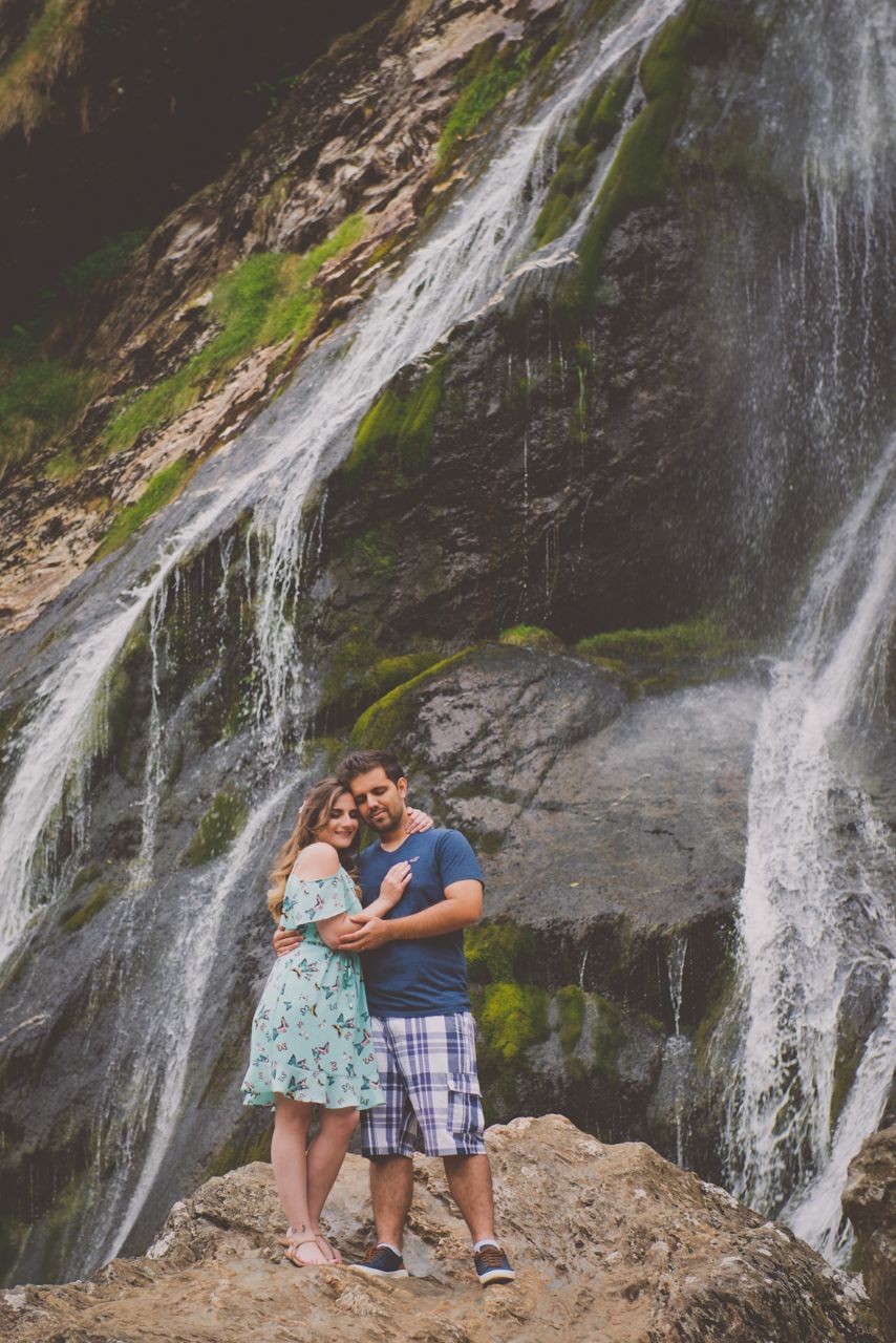 Couple sharing a hug with closed eyes in front of Powescourt waterfall in Ireland