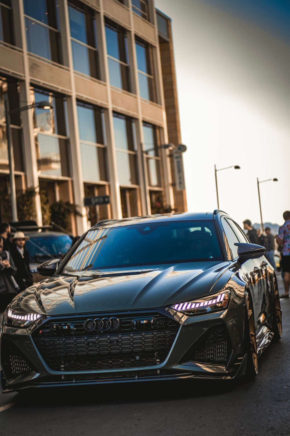 Black Audi RS front view showcasing aggressive grille design and LED headlights on urban street.