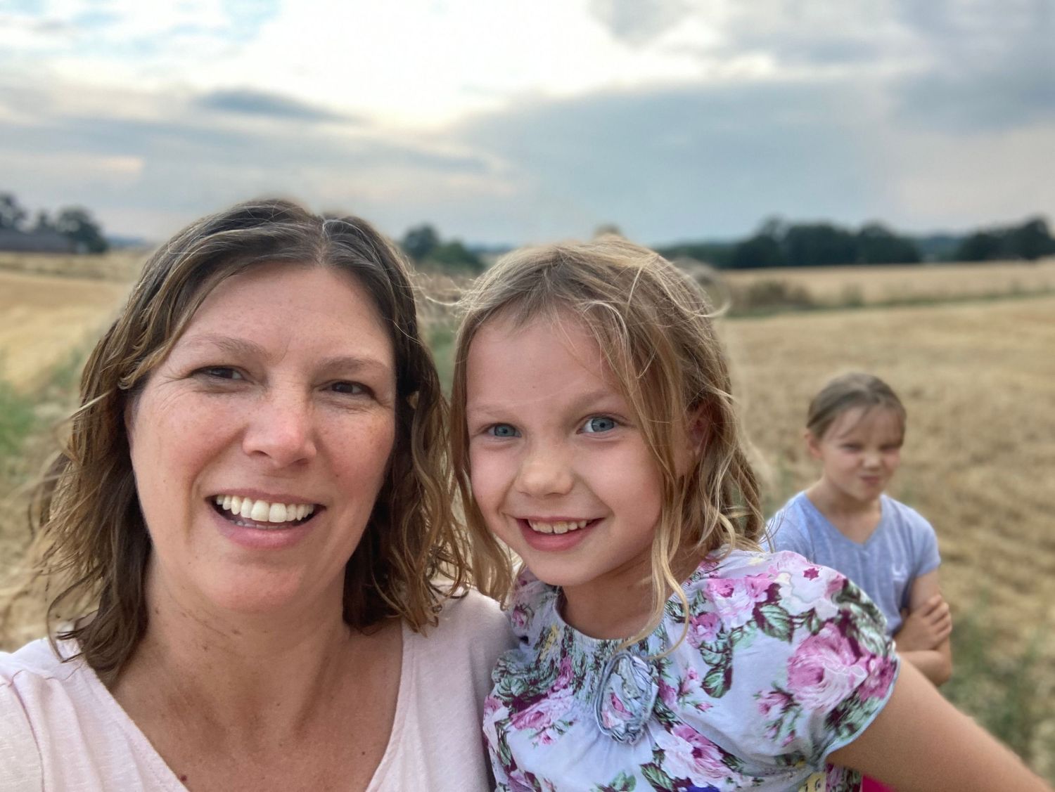 photo of Helen with daughter in arms girl in background