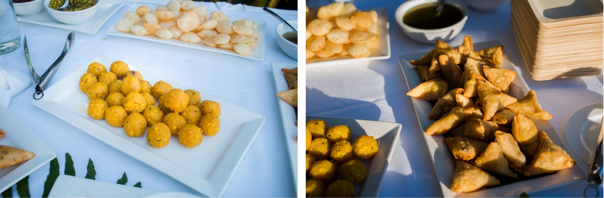 Appetizers and snacks arranged on white serving platters at a catered event.