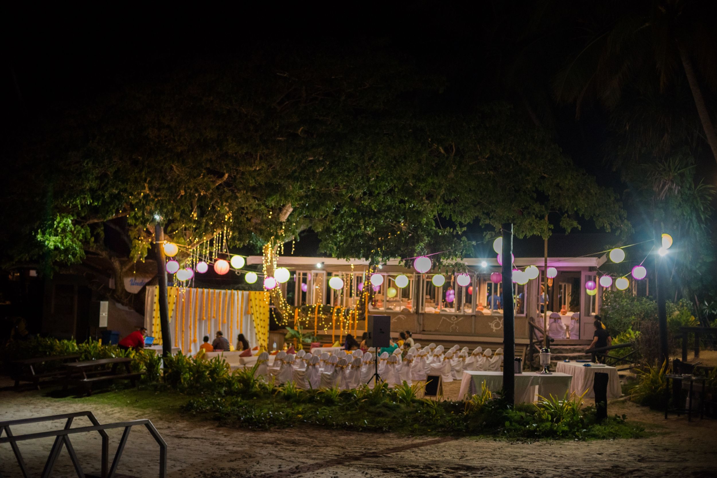 Outdoor wedding venue at night with string lights creating a romantic ambiance.
