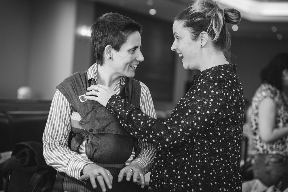 Two people sharing an intimate conversation in polka dot and striped clothing.