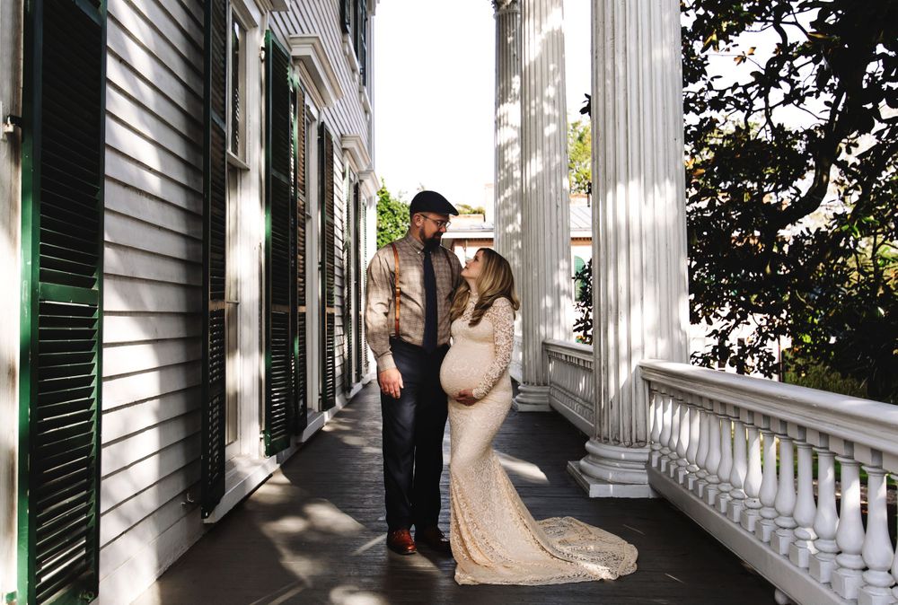 Elegant bridal photos taken on a white columned porch of a historic mansion.