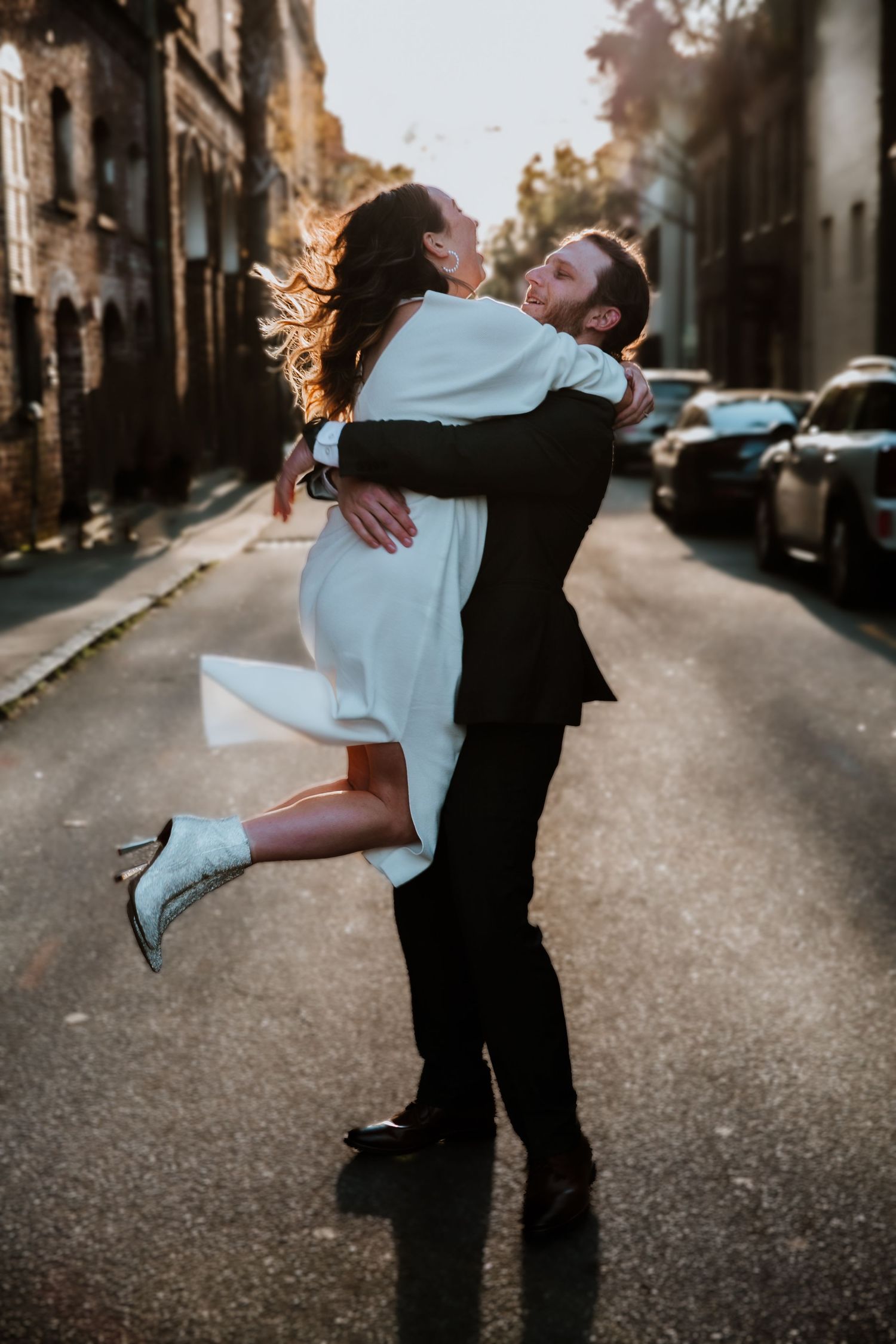 A couple spins around together on the streets of Charleston