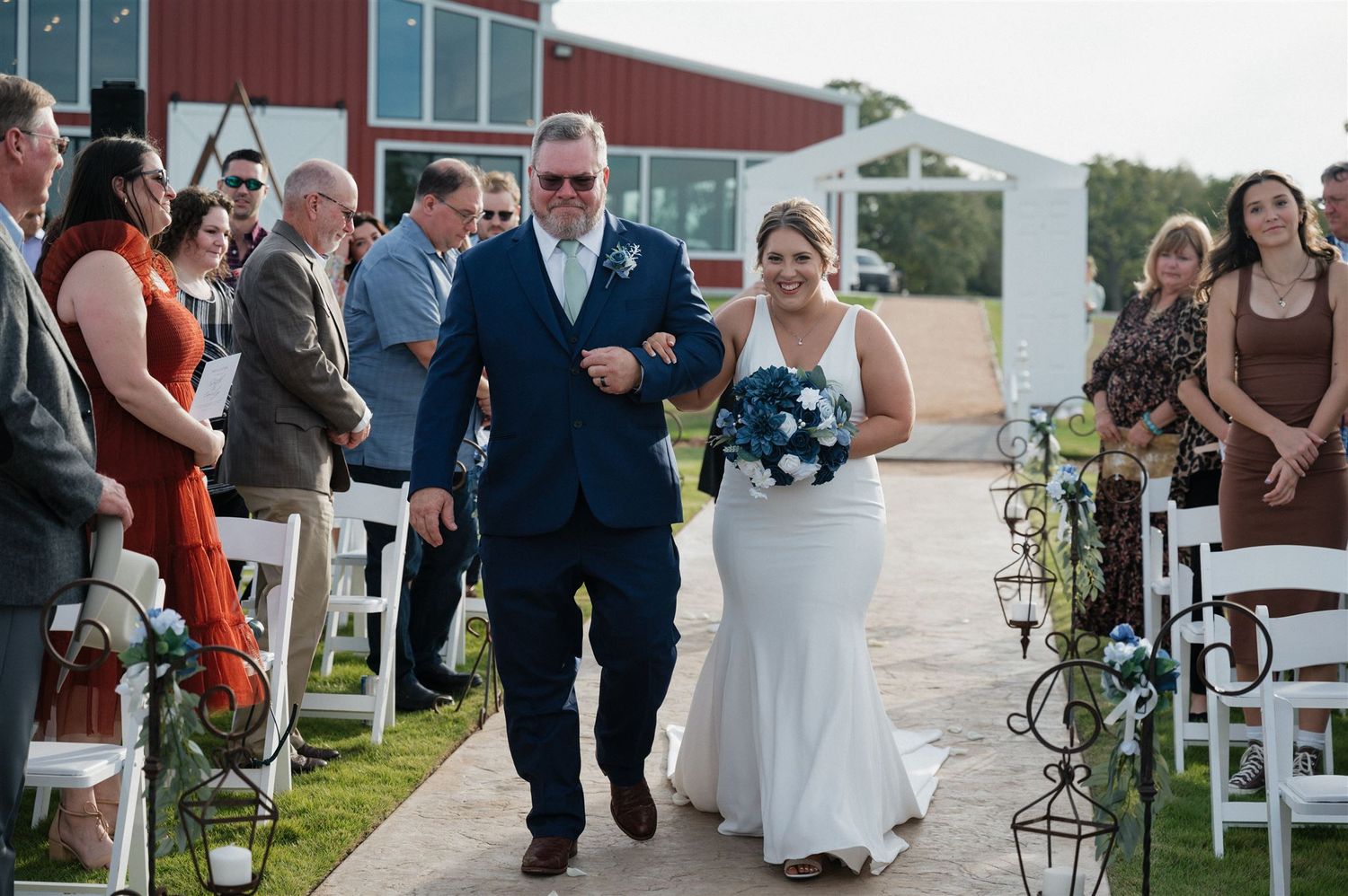 bride walking down the aisle with her father at Fannin Oaks in Madisonville, Texas