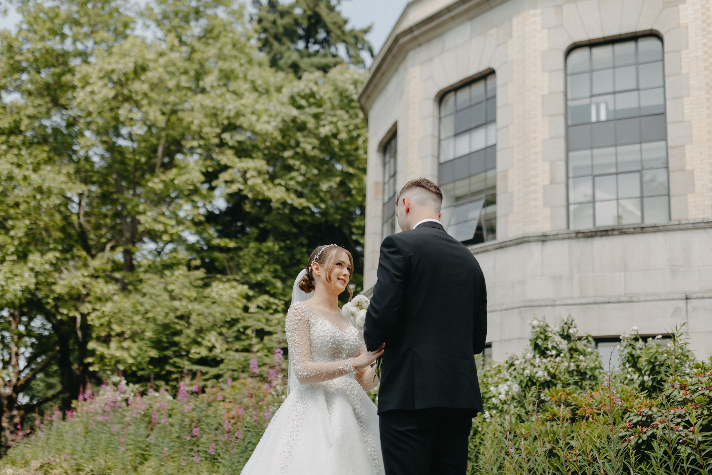 A romantic wedding moment shared in front of a historic building.