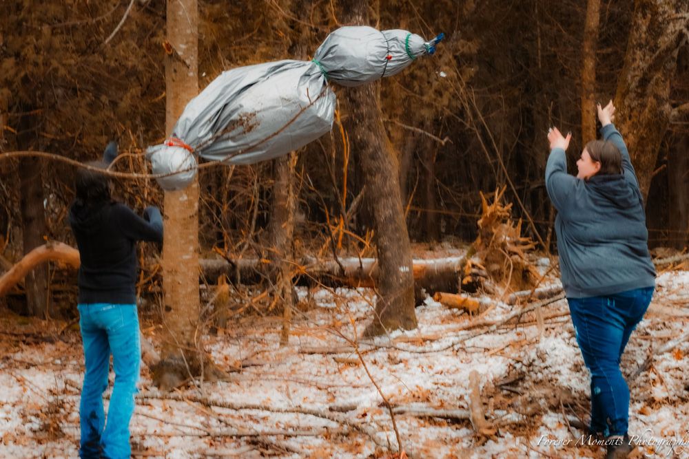 Group enjoying outdoor winter activities in a snow-covered forest.