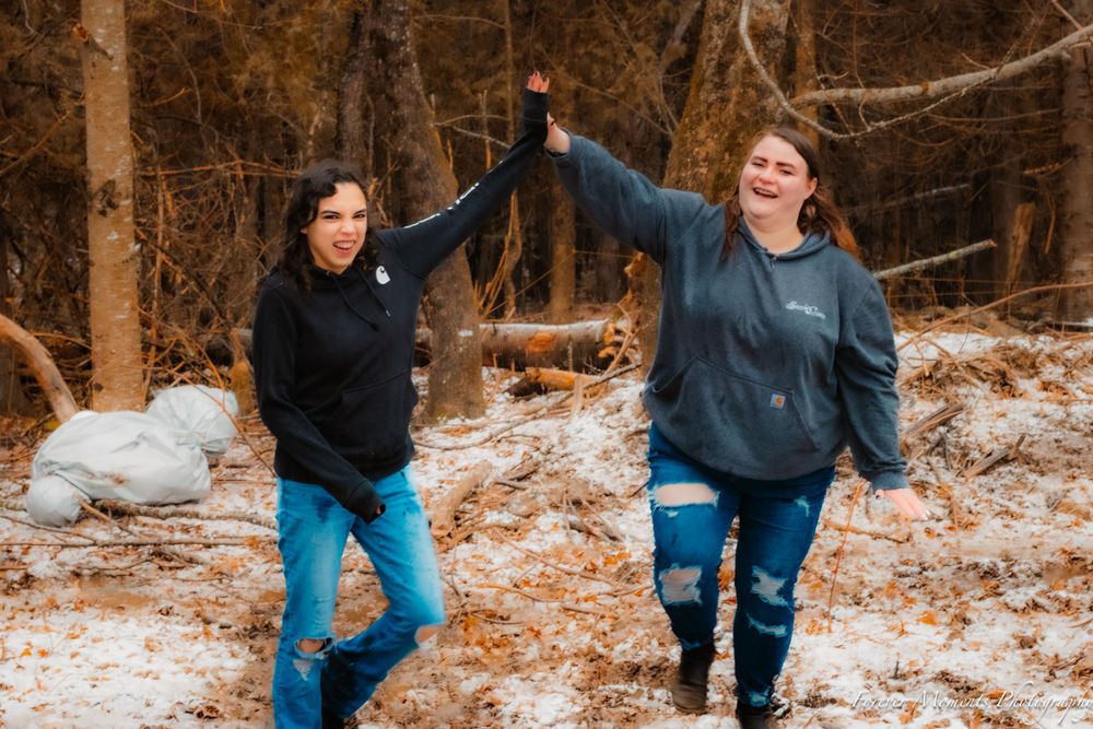 People playing in snowy woods during winter activities.