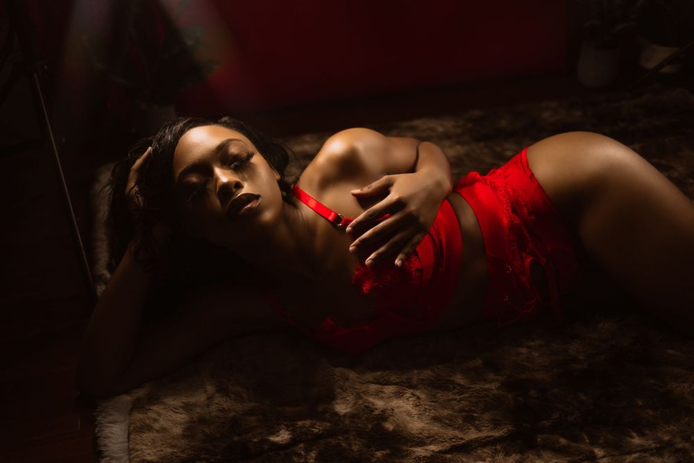 woman laying down in red lingerie