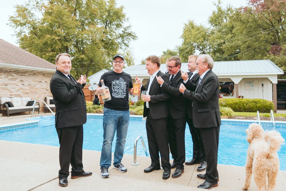 The Groom and groomsmen pose with the liquor guy.