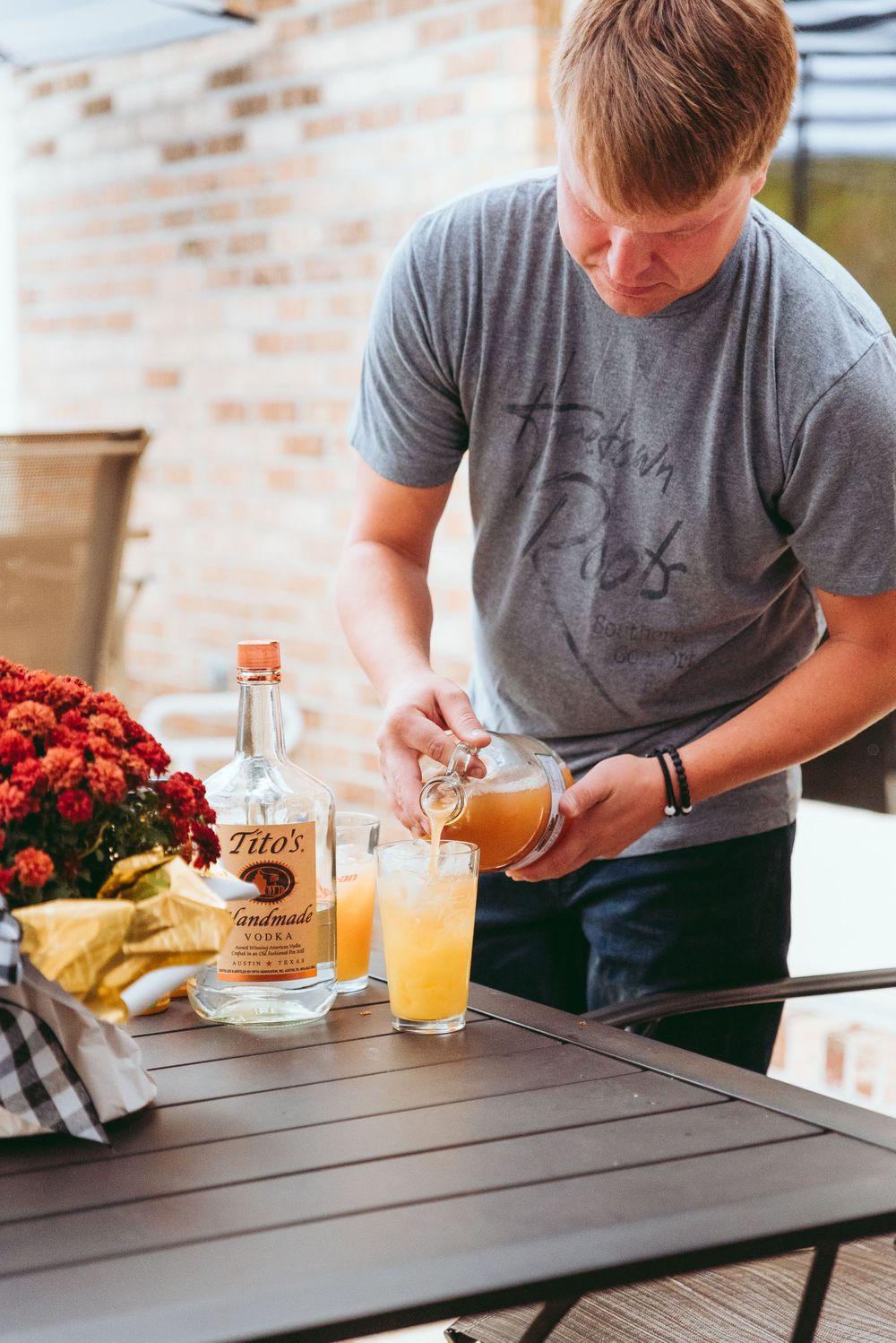 Groom prepares wedding day drink.