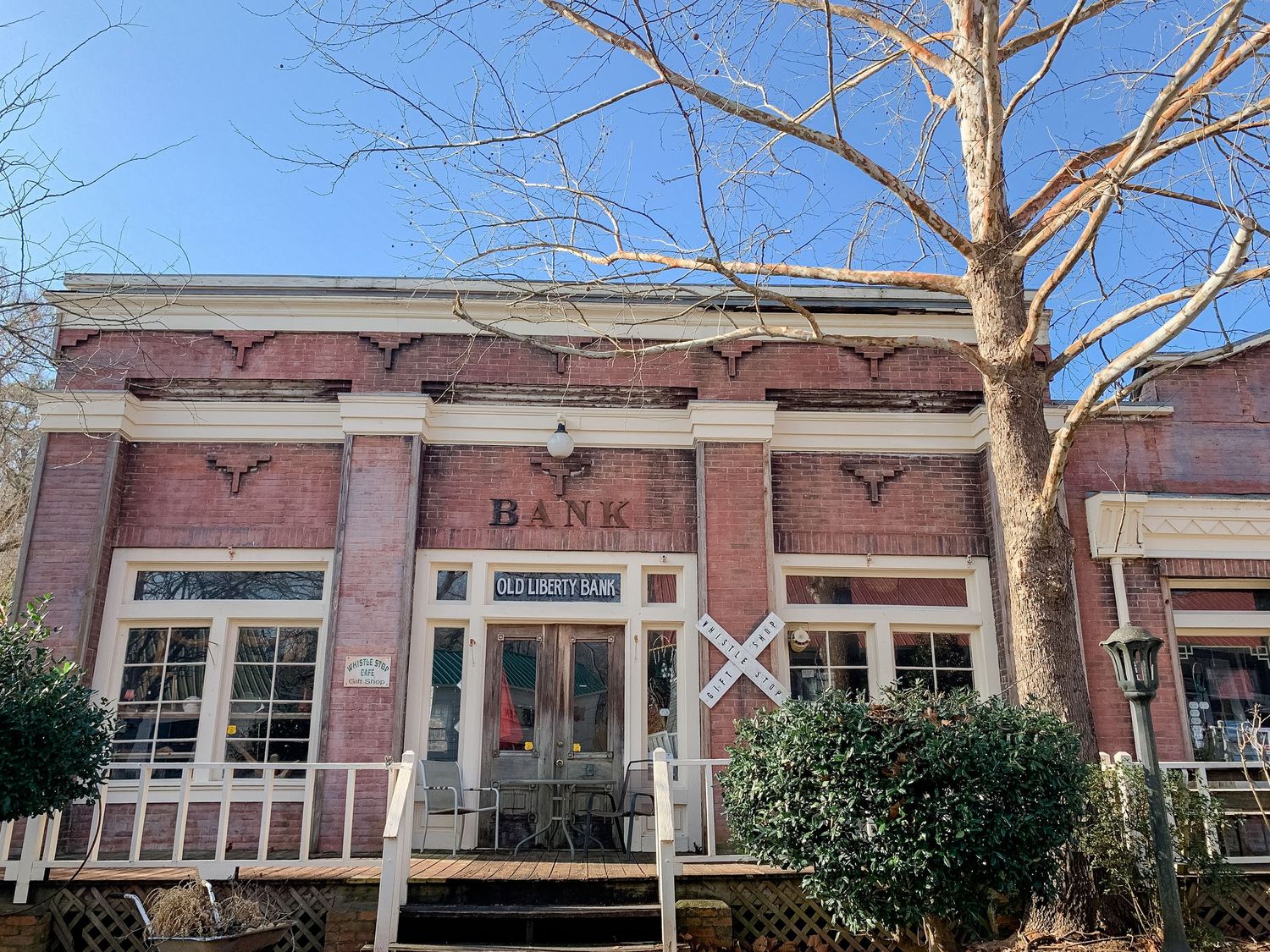 Vintage pink brick storefront with large windows and classic architectural details.