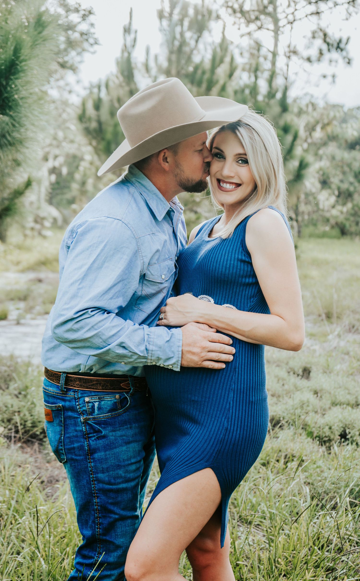 Outdoor Maternity Session at Thatcher Park, Lithia, FL; husband kissing pregnant wife in the scrub brush