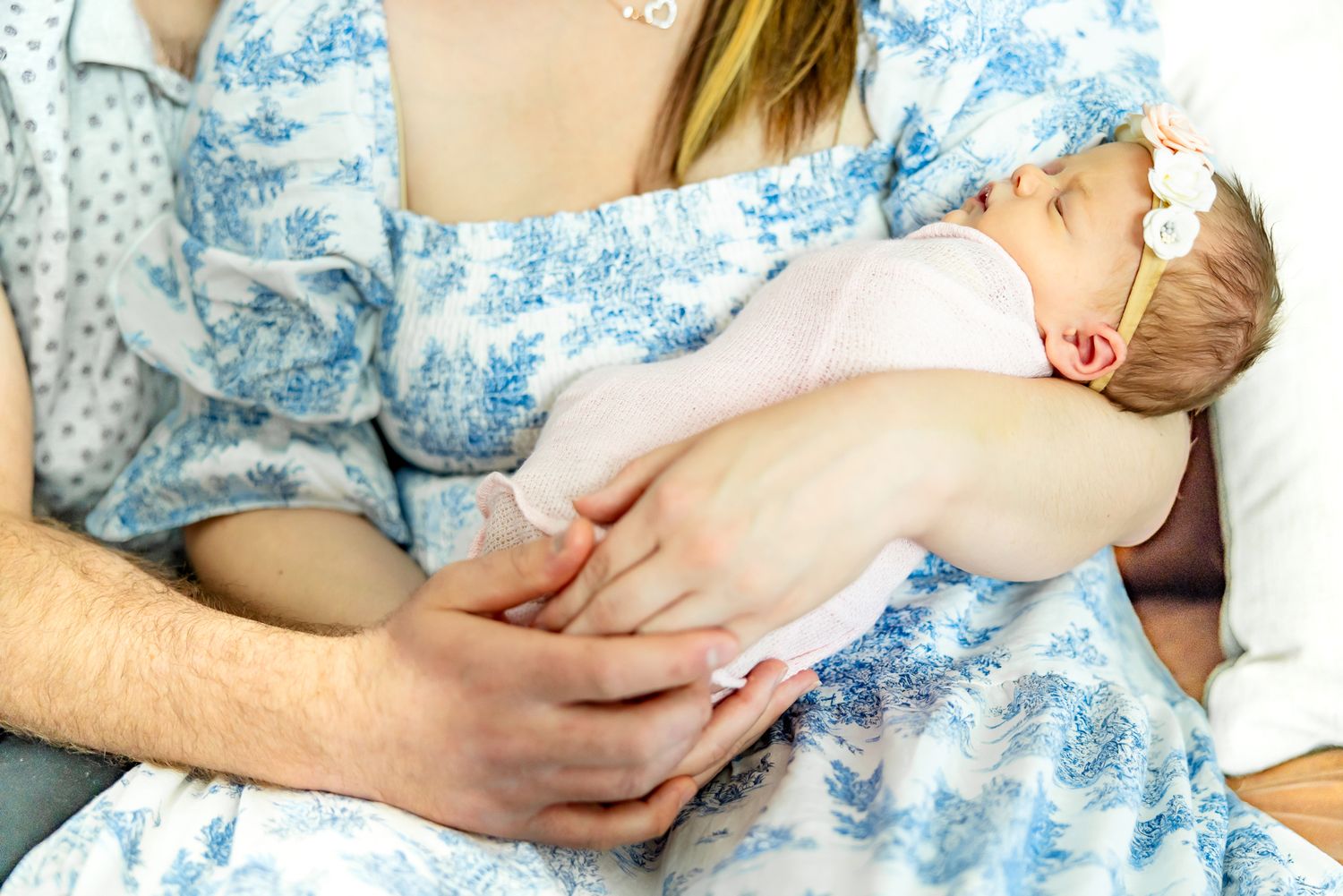 Close up of baby girl sleeping in her mom's arms during lifestyle newborn photos in Colorado Springs.