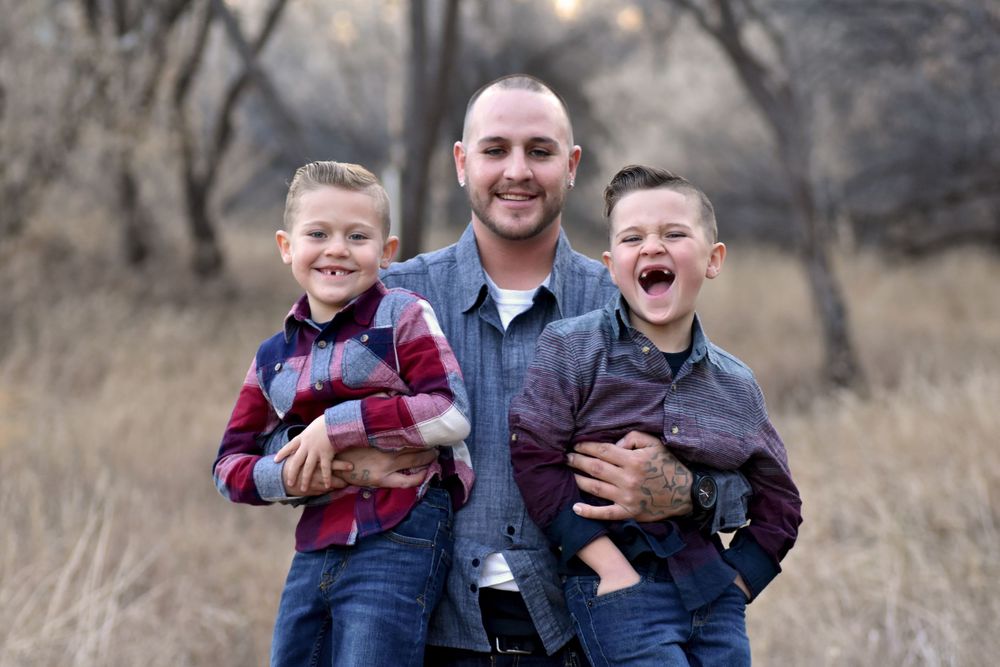 Father holding his two boys