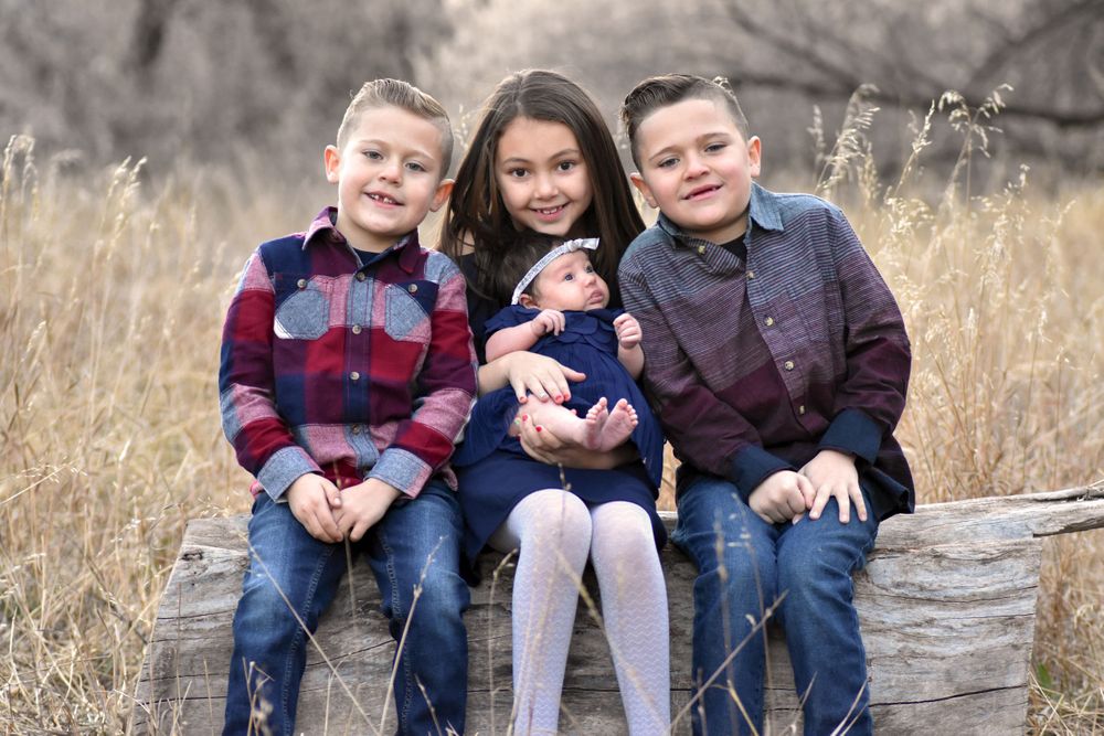 Little kids sitting on a log