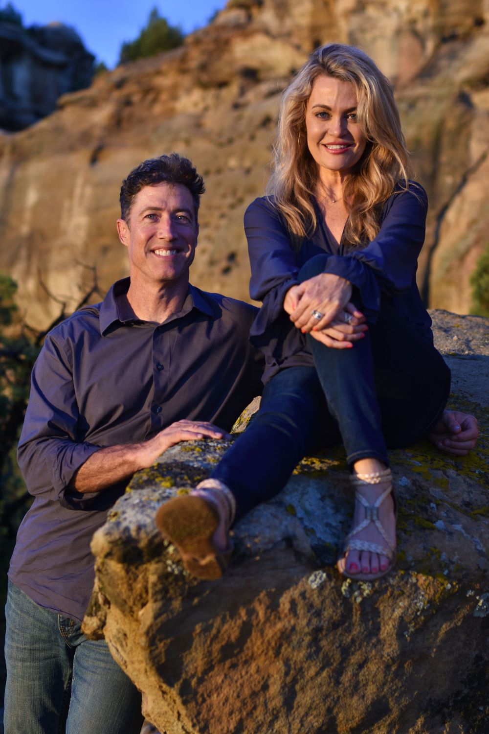 Couple sitting on rock in the desert