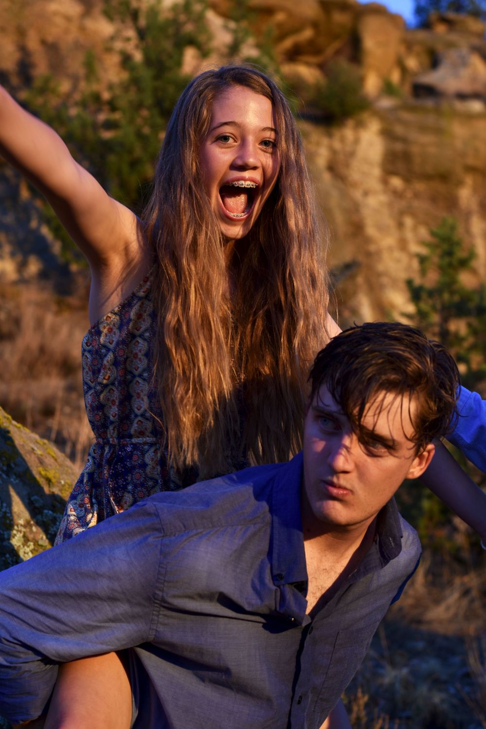 Sister sitting on brother's back