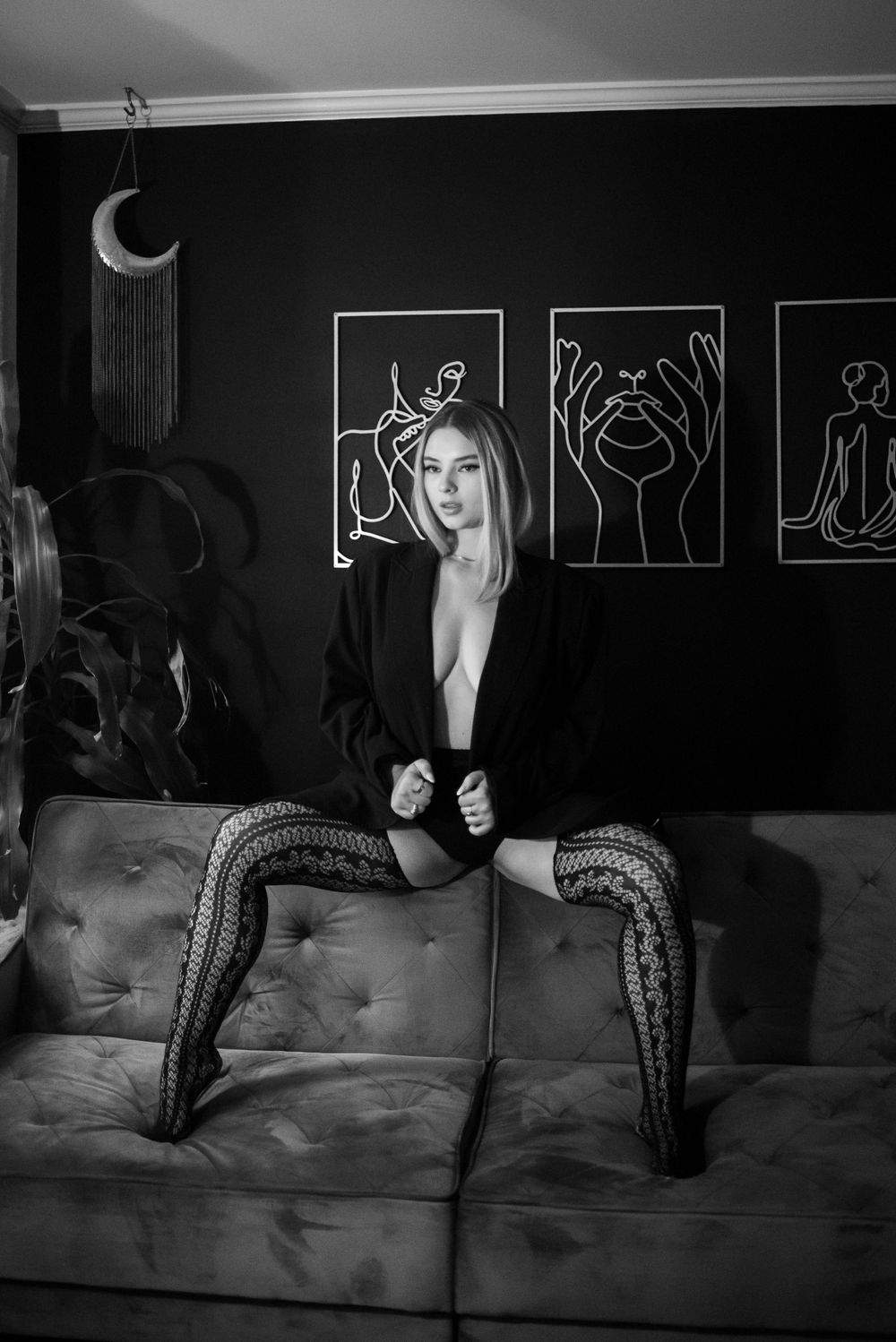 Black and white boudoir with model wearing blazer and tights.