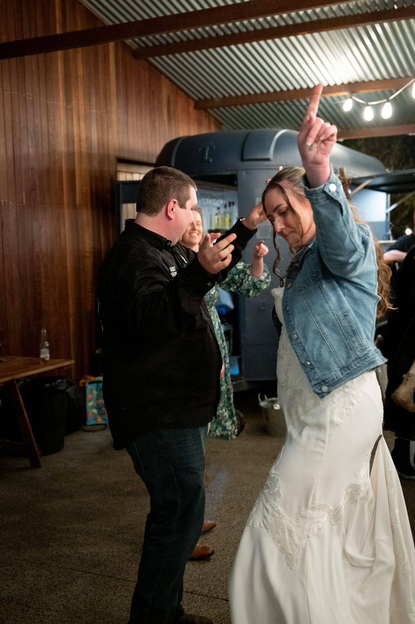 Wedding couple dancing at reception in a barn