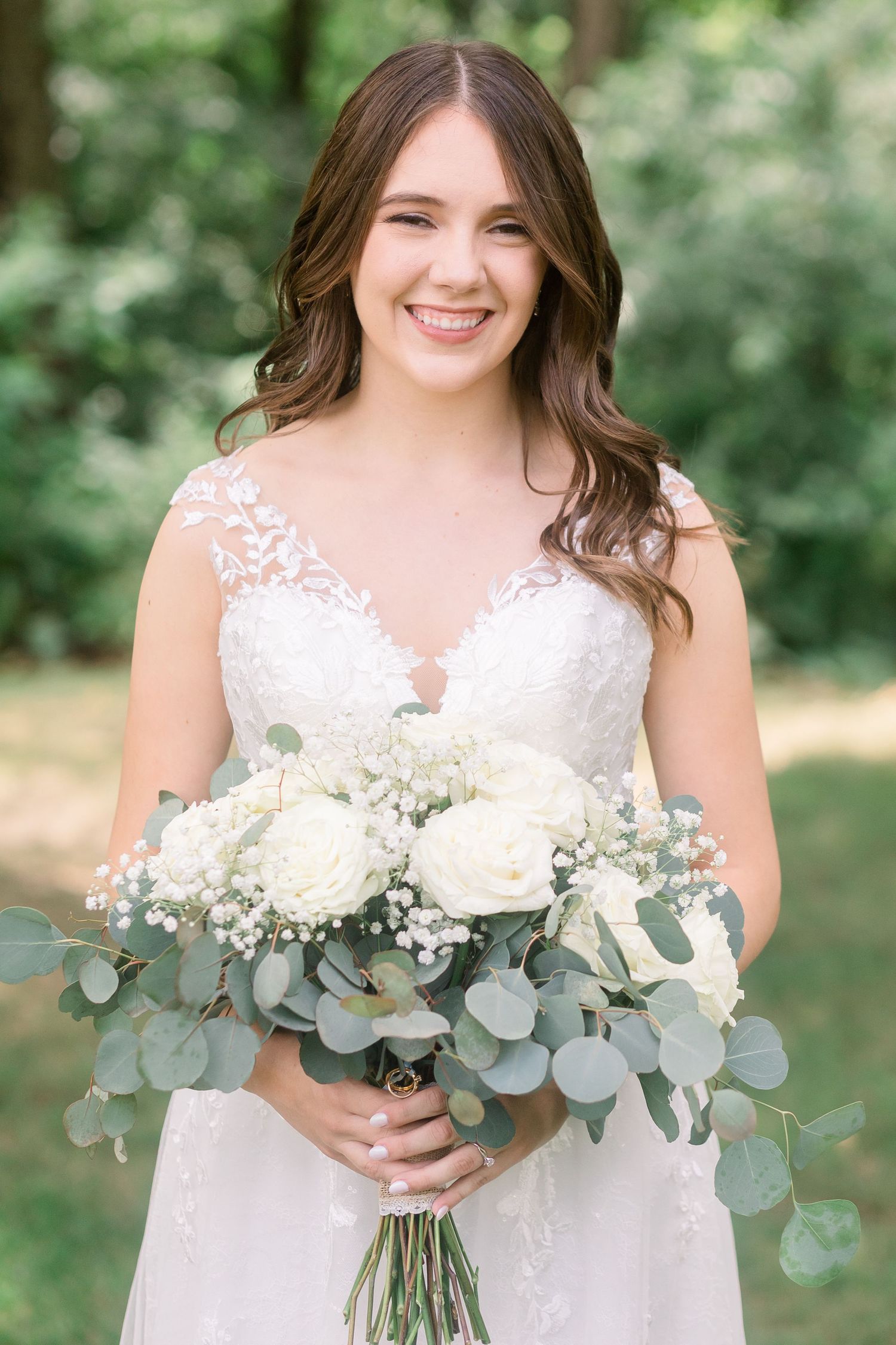 Elegant bridal bouquet features white flowers and silvery eucalyptus leaves.