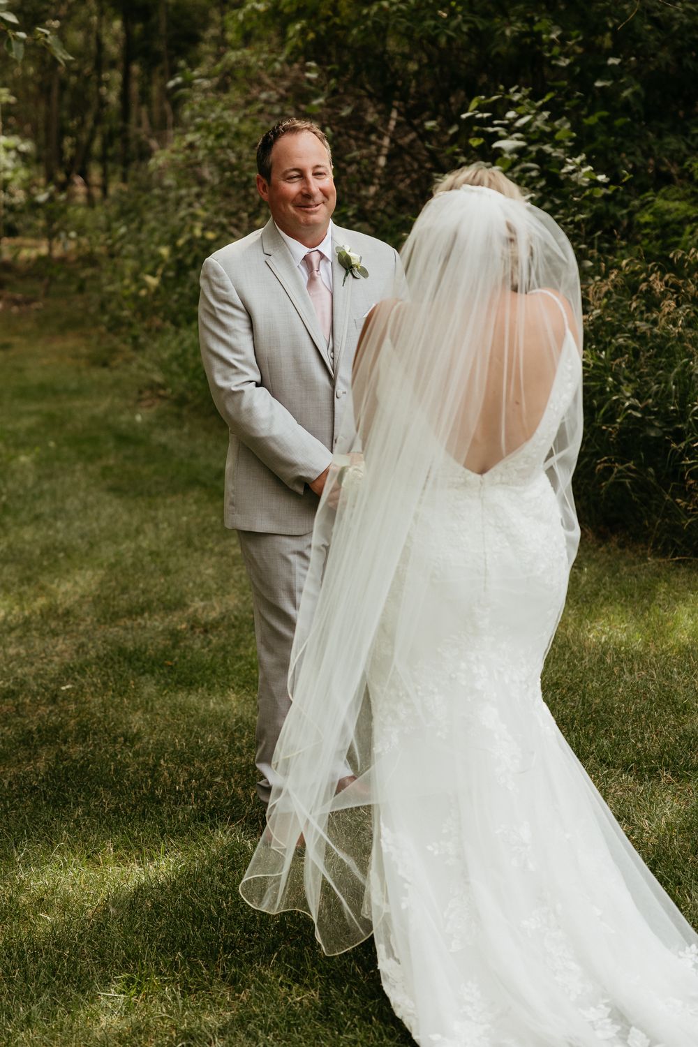A romantic wedding moment captured in an outdoor garden setting.