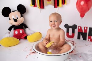 Mickey Mouse themed bath time scene with colorful decorations and party elements.