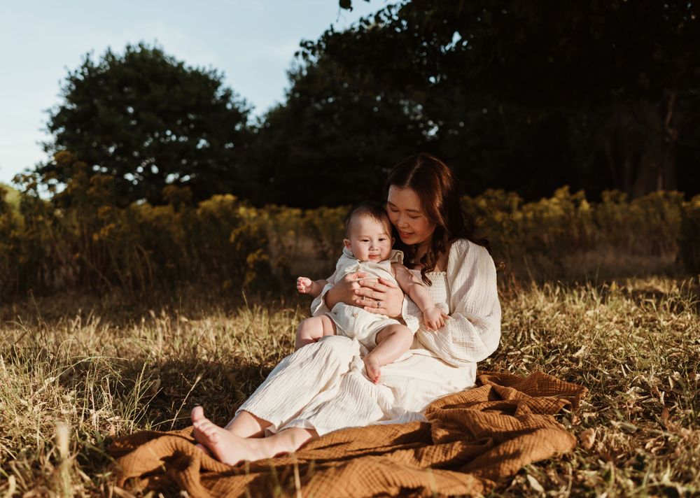 Peaceful outdoor portrait on brown blanket in autumn field.