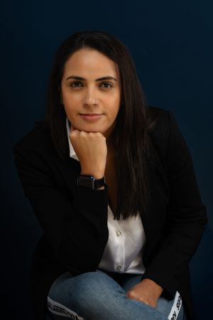 Professional portrait series against a dark blue background with dramatic studio lighting.