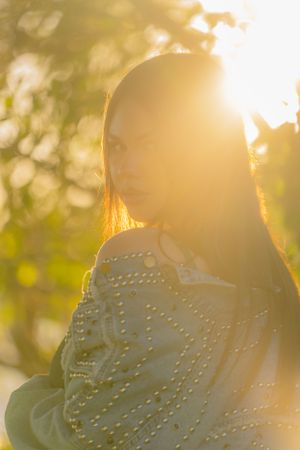 Sun flare through delicate white lace fabric creating a dreamy golden hour effect.