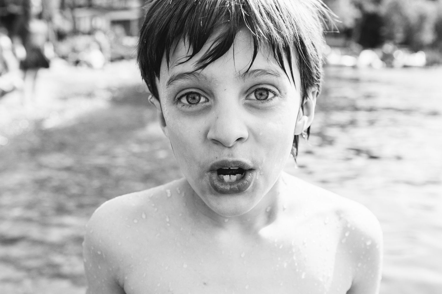 Close-up black and white portrait showing surprised expression in water.