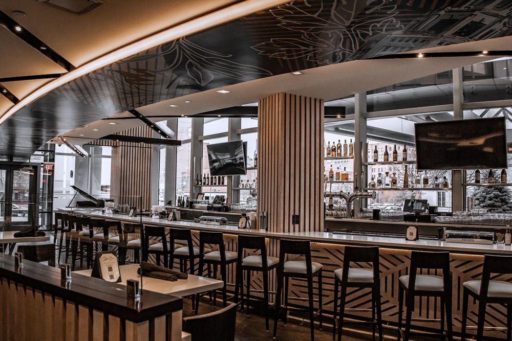 Upscale bar area with wood accents and modern pendant lighting.