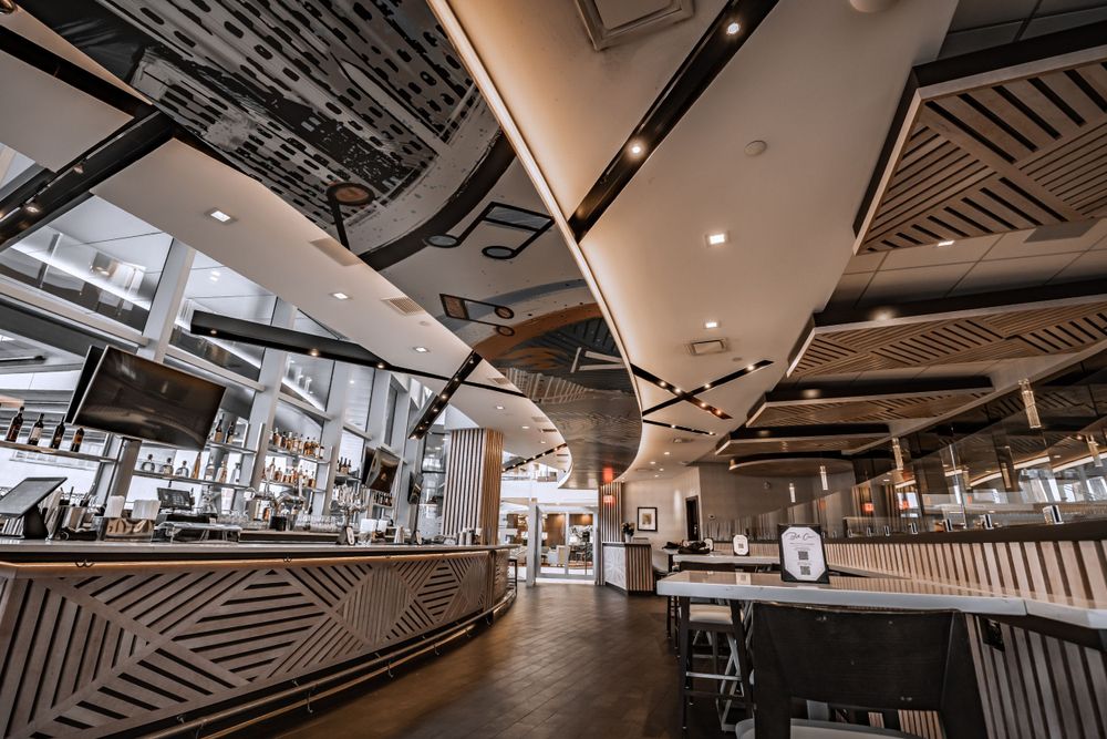 Spacious restaurant interior with geometric decor and modern architectural elements.