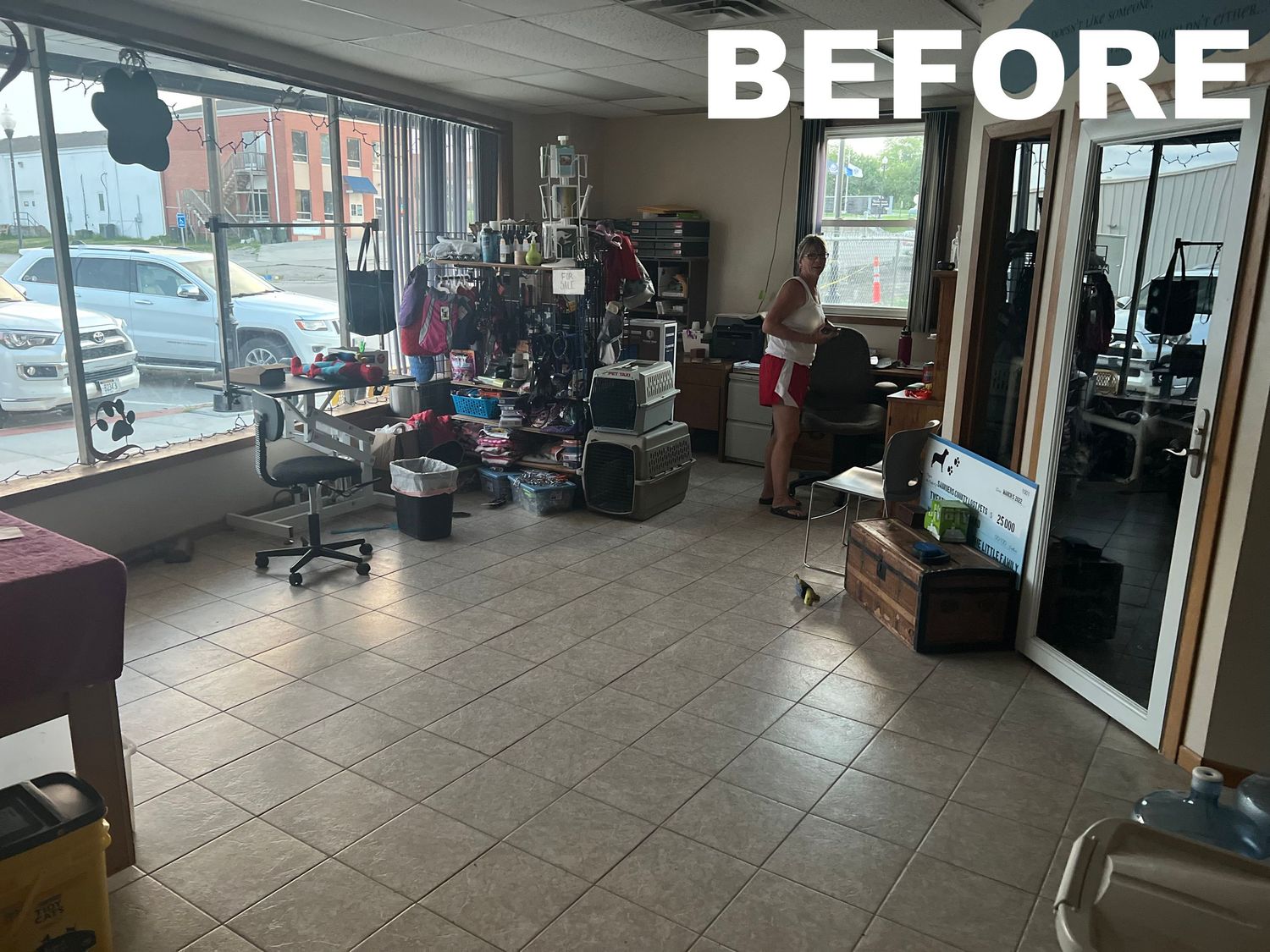 Before photo showing an empty commercial space with tiled floors and bare walls.