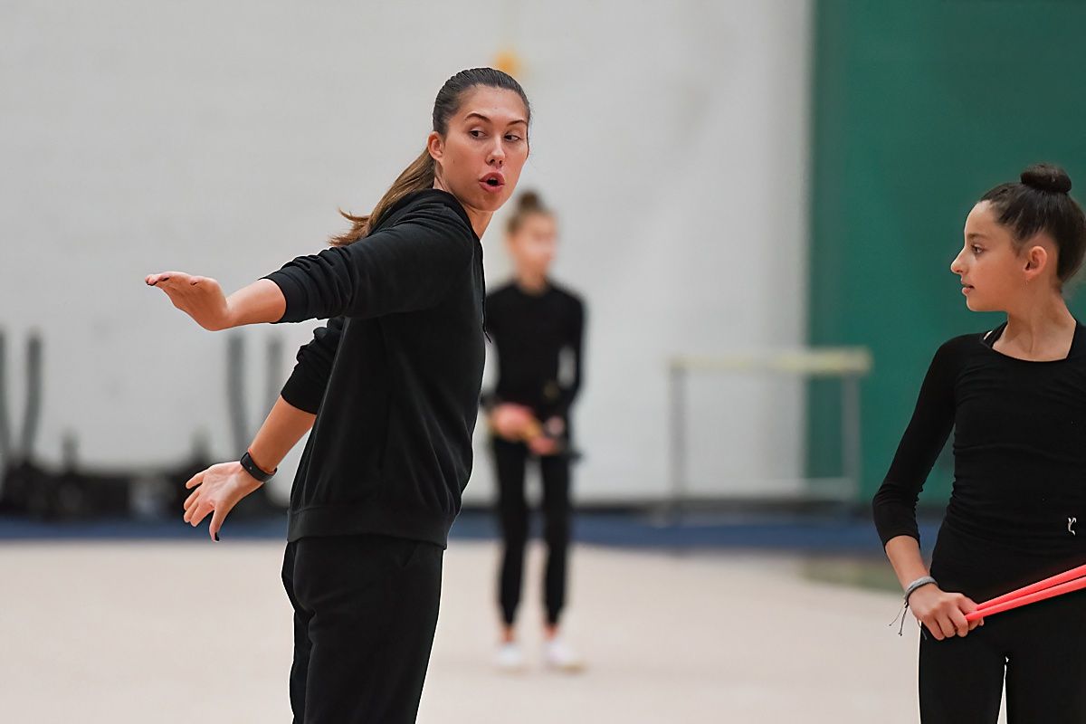 Olympian Karina Lykhvar teaching young gymnast