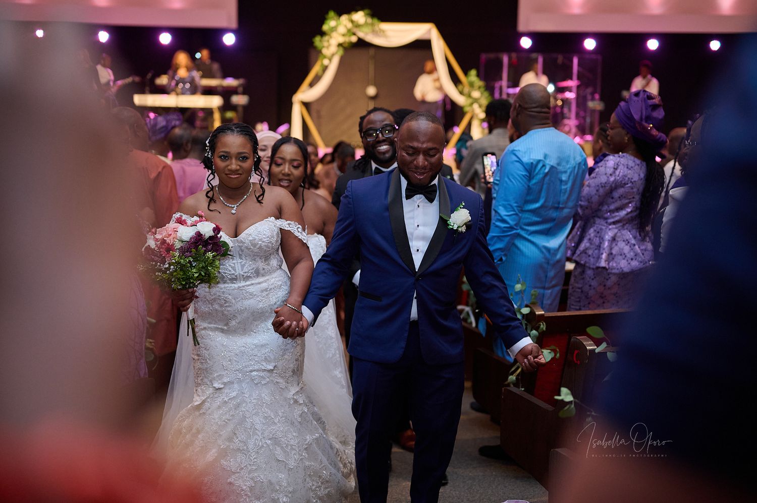Newlyweds making their joyful exit through the venue after wedding ceremony.