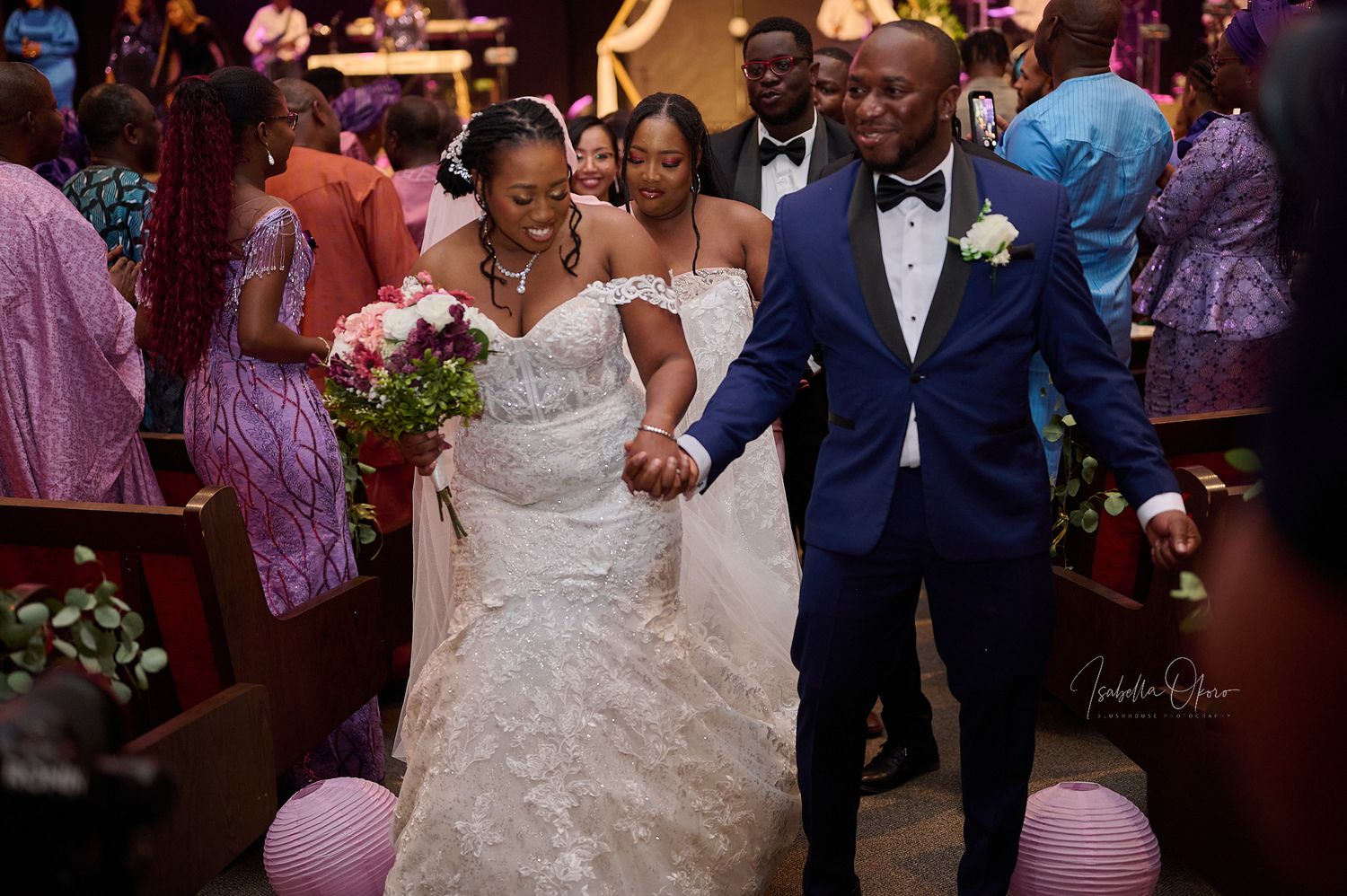 Joyful wedding celebration scene with guests in formal attire.
