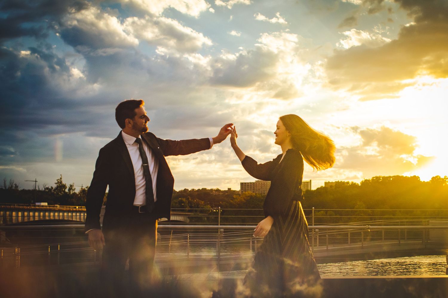 Engaged couple dancing during sunset on top of Kennedy Center rooftop