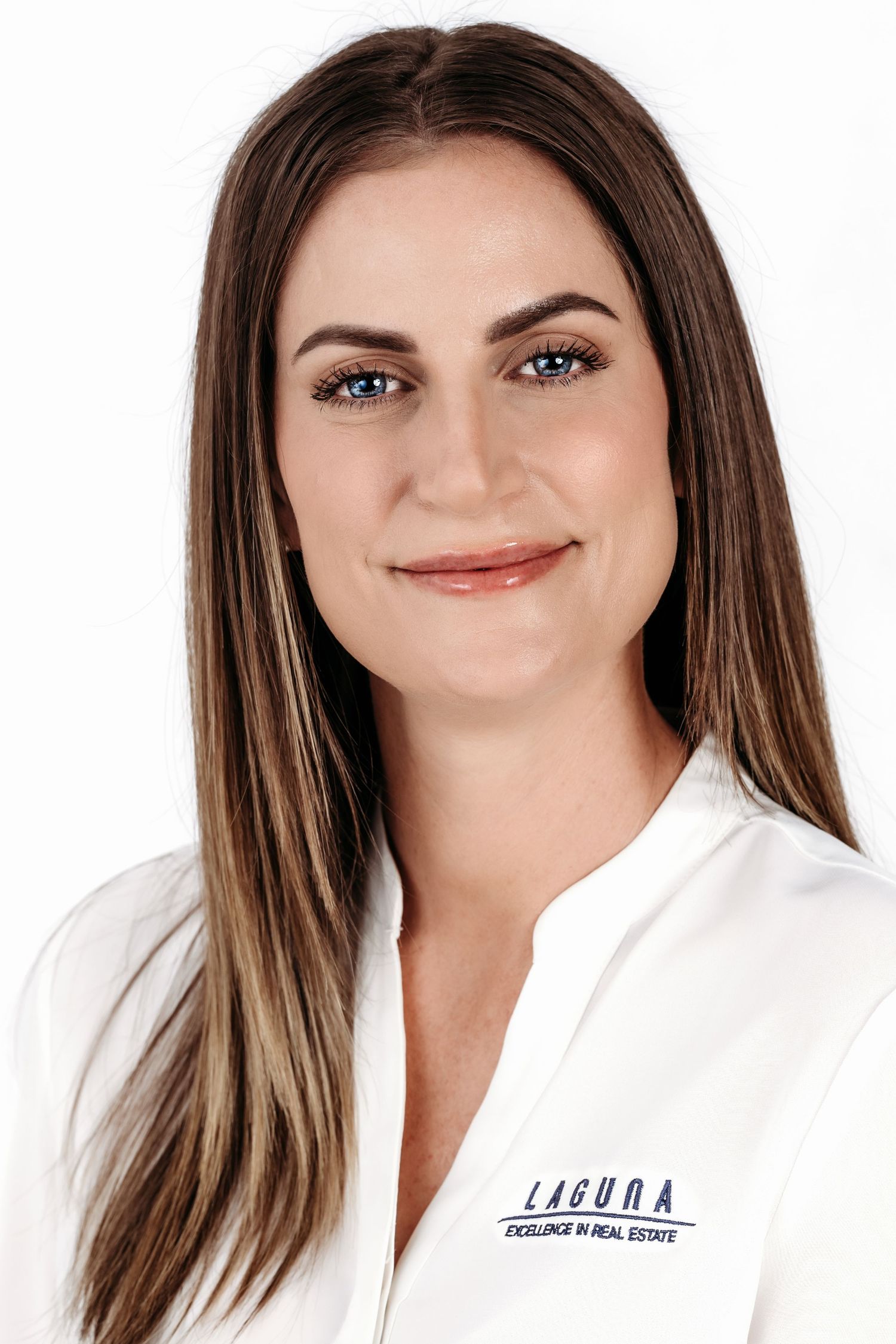 Professional headshot of a woman in a white lab coat against a light background.