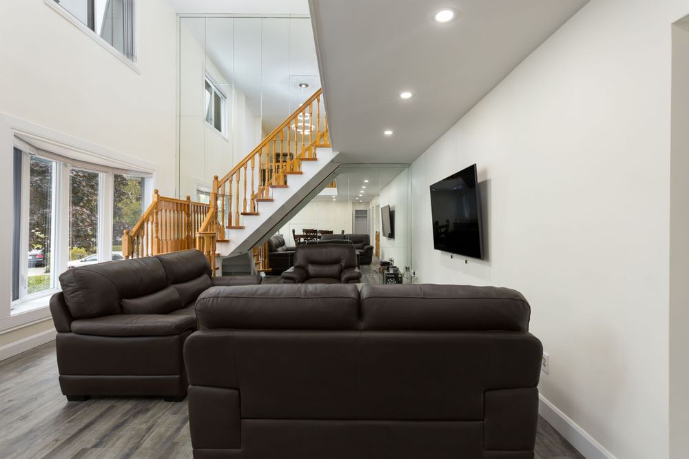 Bright and spacious living room with beautiful window view. Taken by professional real estate photographer.