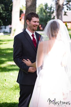 groom smiling at bride for first look