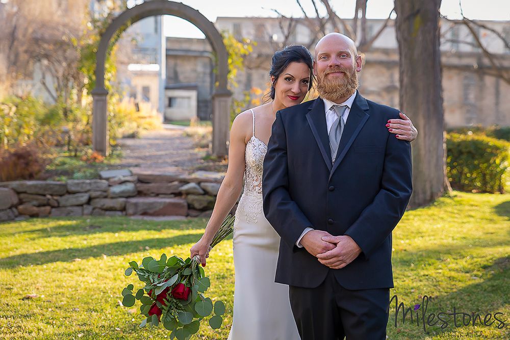 bride standing behind groom for first look