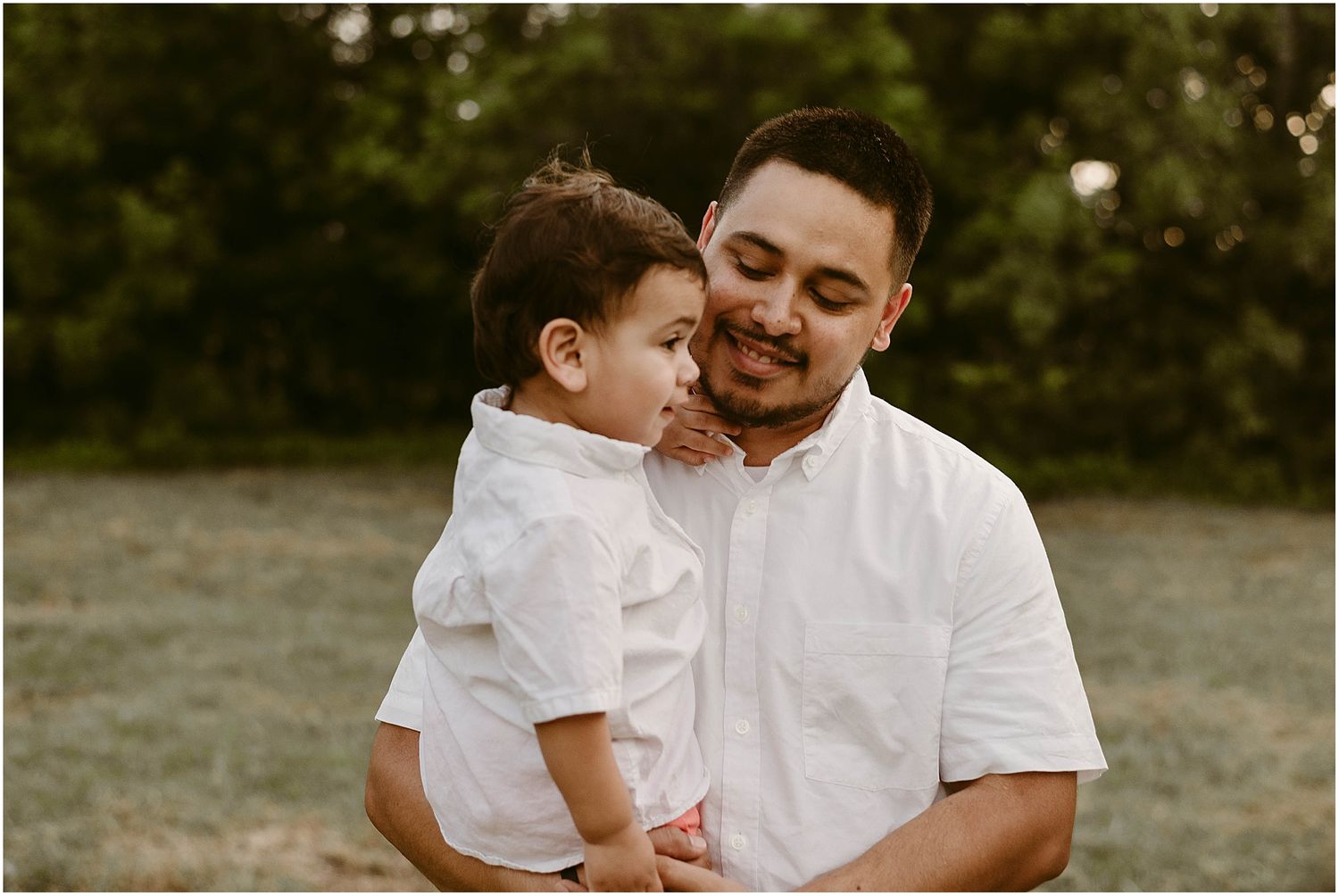 An intimate moment between parent and child during an outdoor family photoshoot.