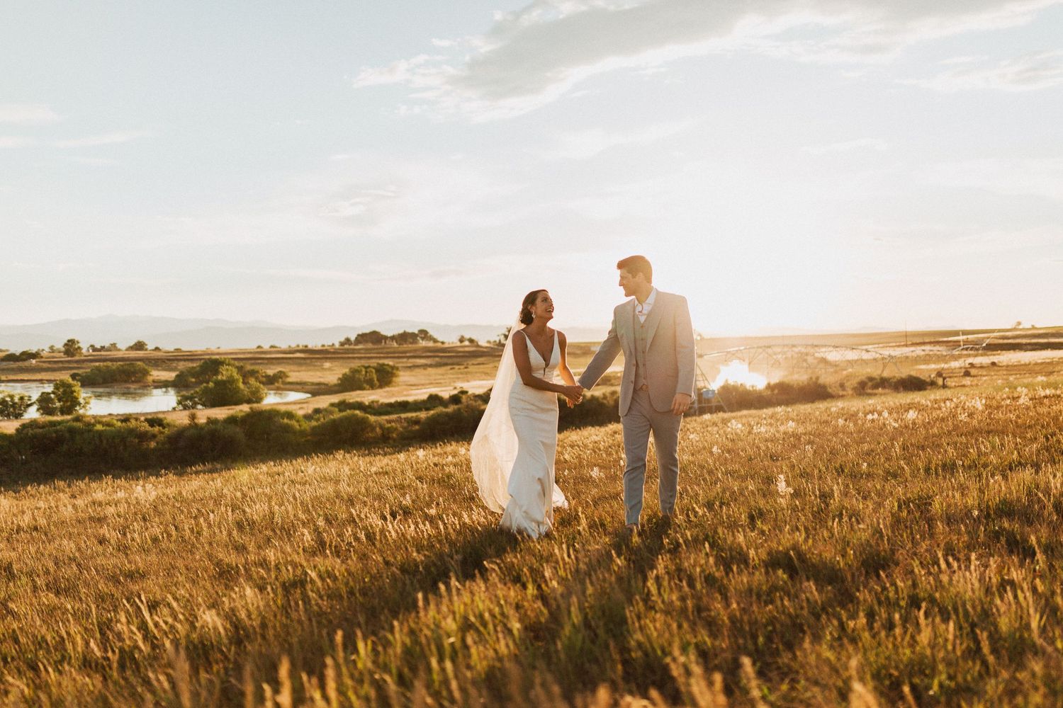 Bride + Groom Walking Through Field