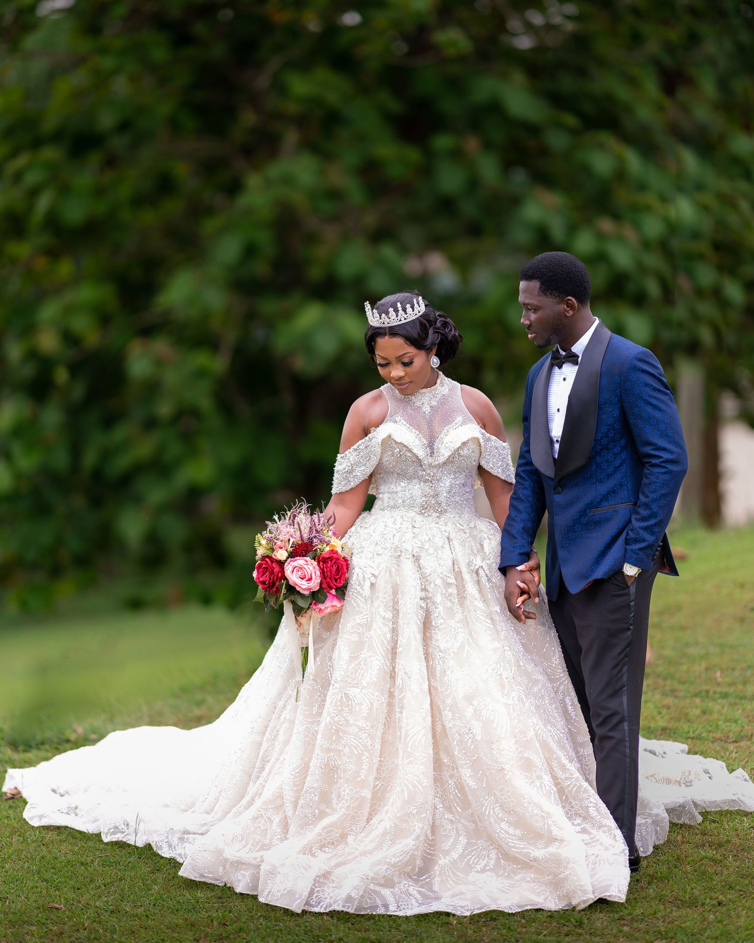 A romantic wedding photo series showing a couple in a white gown and blue suit posing together on grass.