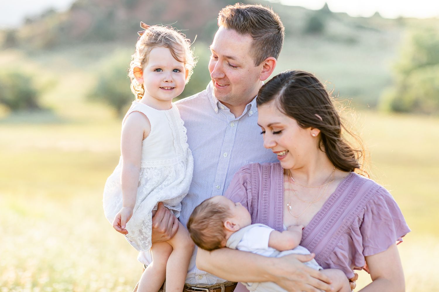 Parents with toddler girl snuggle their new baby boy in Larkspur, Colorado.